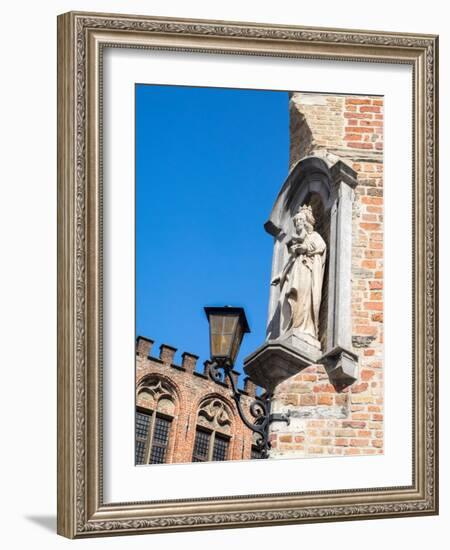 Belgium, Brugge. A stone statue on the cornerstone of a building.-Julie Eggers-Framed Photographic Print