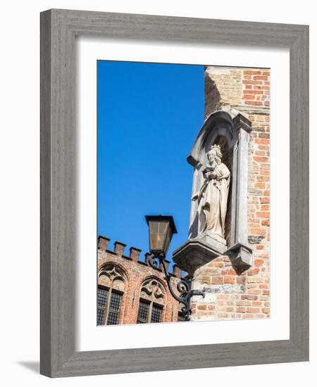 Belgium, Brugge. A stone statue on the cornerstone of a building.-Julie Eggers-Framed Photographic Print