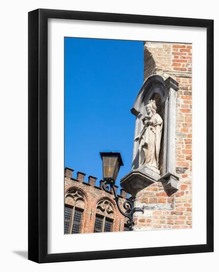 Belgium, Brugge. A stone statue on the cornerstone of a building.-Julie Eggers-Framed Photographic Print