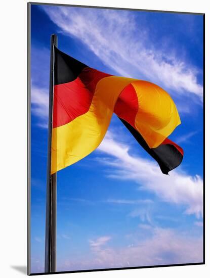 Berlin, Germany. Flag of the Federal Republic Of Germany on a flagpole waving in the breeze.-Miva Stock-Mounted Photographic Print