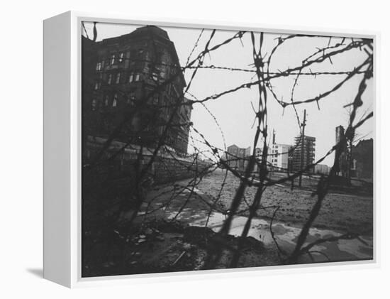 Berlin Wall Stretches Divisionally Between Buildings That Were Once on Common Ground-Paul Schutzer-Framed Premier Image Canvas