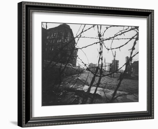 Berlin Wall Stretches Divisionally Between Buildings That Were Once on Common Ground-Paul Schutzer-Framed Photographic Print