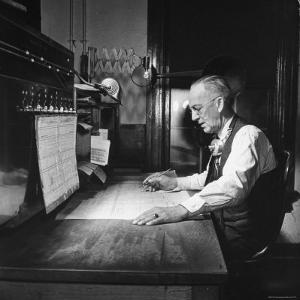 Santa Fe Railroad Dispatcher Working on a Freight Train by Bernard Hoffman