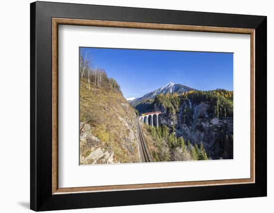 Bernina Express Passes over the Landwasser Viadukt Surrounded by Colorful Woods, Switzerland-Roberto Moiola-Framed Photographic Print