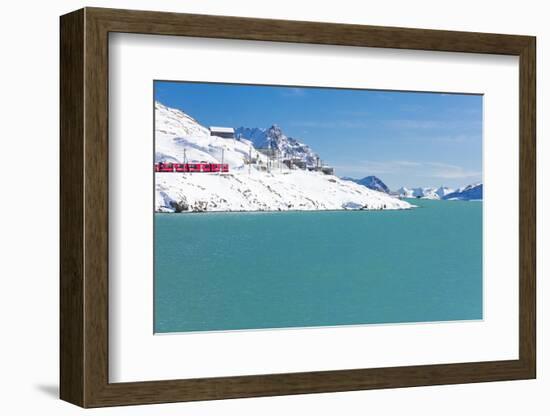 Bernina Express train in the snowy valley surrounded by Lake Bianco, Bernina Pass, Canton of Graubu-Roberto Moiola-Framed Photographic Print