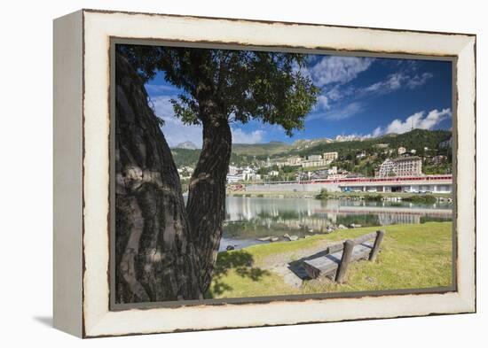 Bernina Express train runs past the village of St. Moritz surrounded by lake, Canton of Graubunden,-Roberto Moiola-Framed Premier Image Canvas