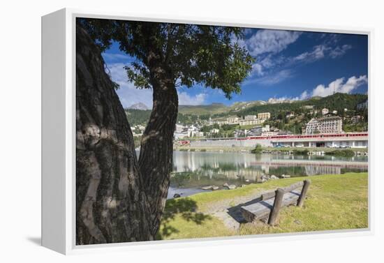 Bernina Express train runs past the village of St. Moritz surrounded by lake, Canton of Graubunden,-Roberto Moiola-Framed Premier Image Canvas