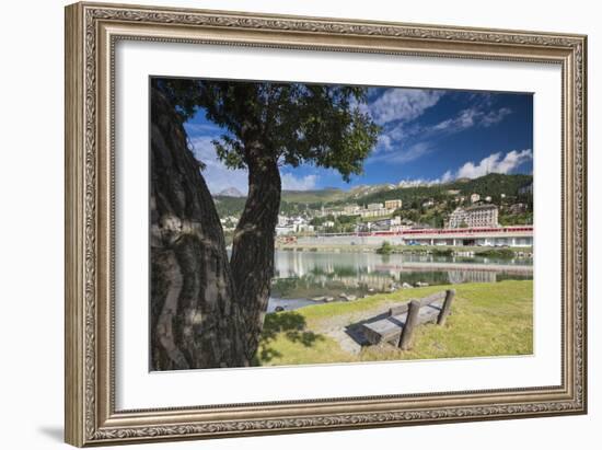 Bernina Express train runs past the village of St. Moritz surrounded by lake, Canton of Graubunden,-Roberto Moiola-Framed Photographic Print