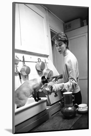 Bettina Graziani Prepares Coffee in Her Kitchen with One of Her Siamese Cats, Paris, France, 1952-Nat Farbman-Mounted Photographic Print