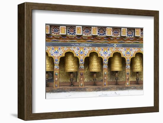 Bhutan. Spinning prayer wheels along a temple wall.-Brenda Tharp-Framed Photographic Print