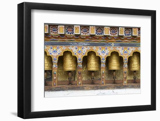 Bhutan. Spinning prayer wheels along a temple wall.-Brenda Tharp-Framed Photographic Print