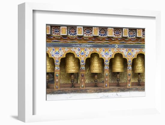 Bhutan. Spinning prayer wheels along a temple wall.-Brenda Tharp-Framed Photographic Print