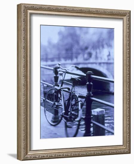 Bicycle on Rail by Canal, Amsterdam, Netherlands-Walter Bibikow-Framed Photographic Print