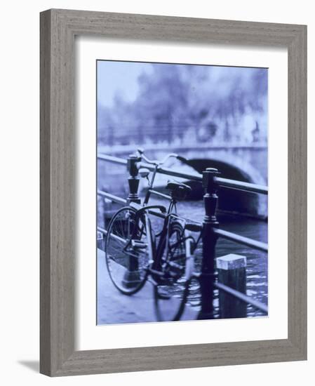 Bicycle on Rail by Canal, Amsterdam, Netherlands-Walter Bibikow-Framed Photographic Print