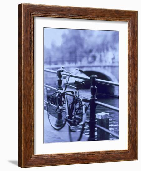 Bicycle on Rail by Canal, Amsterdam, Netherlands-Walter Bibikow-Framed Photographic Print