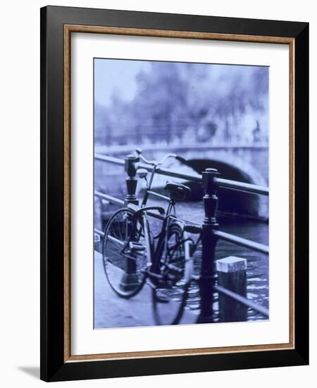 Bicycle on Rail by Canal, Amsterdam, Netherlands-Walter Bibikow-Framed Photographic Print