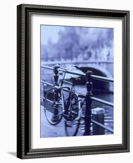 Bicycle on Rail by Canal, Amsterdam, Netherlands-Walter Bibikow-Framed Photographic Print