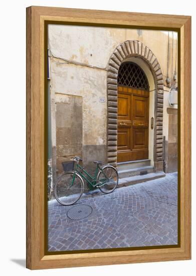 Bicycle parked outside front door, Lucca, Tuscany, Italy, Europe-John Guidi-Framed Premier Image Canvas