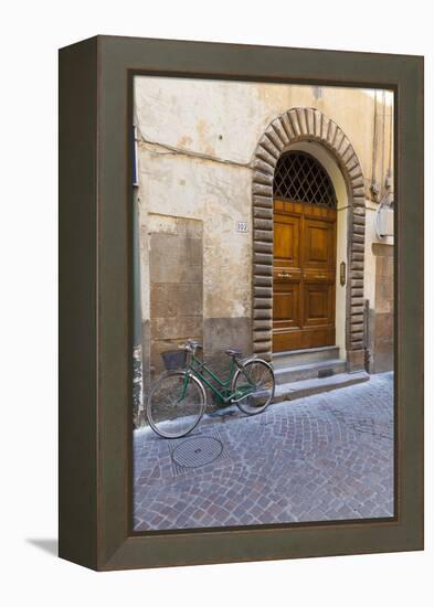 Bicycle parked outside front door, Lucca, Tuscany, Italy, Europe-John Guidi-Framed Premier Image Canvas