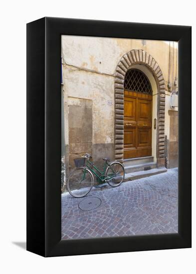 Bicycle parked outside front door, Lucca, Tuscany, Italy, Europe-John Guidi-Framed Premier Image Canvas