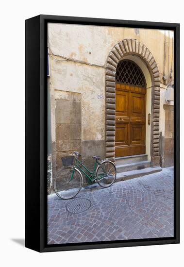 Bicycle parked outside front door, Lucca, Tuscany, Italy, Europe-John Guidi-Framed Premier Image Canvas
