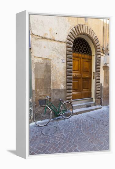 Bicycle parked outside front door, Lucca, Tuscany, Italy, Europe-John Guidi-Framed Premier Image Canvas