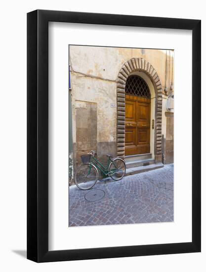 Bicycle parked outside front door, Lucca, Tuscany, Italy, Europe-John Guidi-Framed Photographic Print