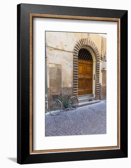 Bicycle parked outside front door, Lucca, Tuscany, Italy, Europe-John Guidi-Framed Photographic Print