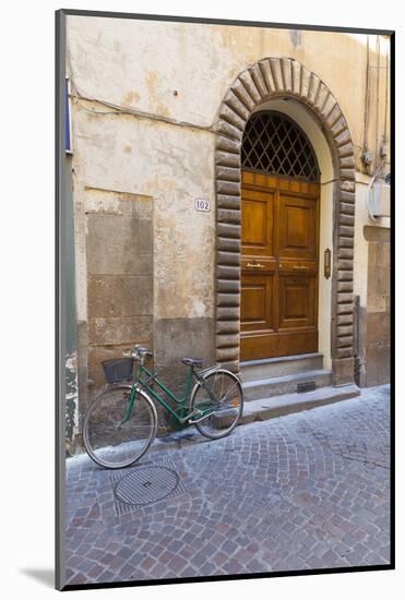 Bicycle parked outside front door, Lucca, Tuscany, Italy, Europe-John Guidi-Mounted Photographic Print