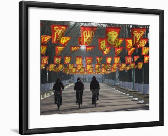 Bicycle Riders at Entranceway to Festival, Ice and Snow Festival, Harbin, Heilongjiang, China-Walter Bibikow-Framed Photographic Print