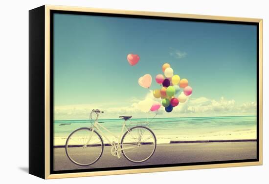 Bicycle Vintage with Heart Balloon on Beach Blue Sky Concept of Love in Summer and Wedding-jakkapan-Framed Premier Image Canvas