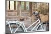 Bicycle with a Basket of a Dried Bouquet Flower Stand in Front of Wooden and Rustic House Backgroun-WichitS-Mounted Photographic Print