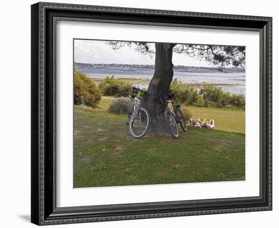 Bicycles by Tree and Couple Relaxing on the Grass, St. Pol De Leon, Carentac in Distance, Brittany-David Hughes-Framed Photographic Print