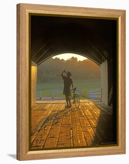 Bicyclist at Covered Bridge, Iowa, USA-Chuck Haney-Framed Premier Image Canvas