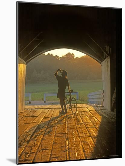 Bicyclist at Covered Bridge, Iowa, USA-Chuck Haney-Mounted Photographic Print