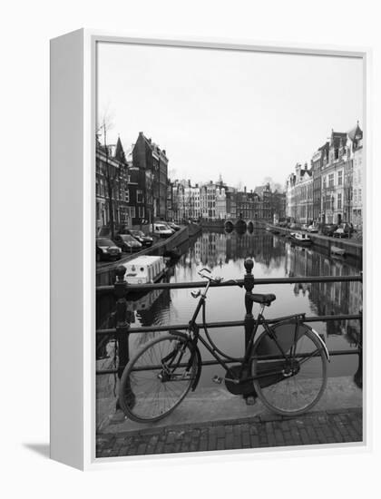 Black and White Image of an Old Bicycle by the Singel Canal, Amsterdam, Netherlands, Europe-Amanda Hall-Framed Premier Image Canvas