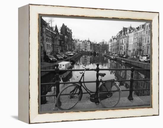 Black and White Imge of an Old Bicycle by the Singel Canal, Amsterdam, Netherlands, Europe-Amanda Hall-Framed Premier Image Canvas