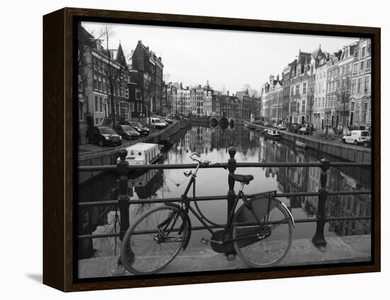 Black and White Imge of an Old Bicycle by the Singel Canal, Amsterdam, Netherlands, Europe-Amanda Hall-Framed Premier Image Canvas