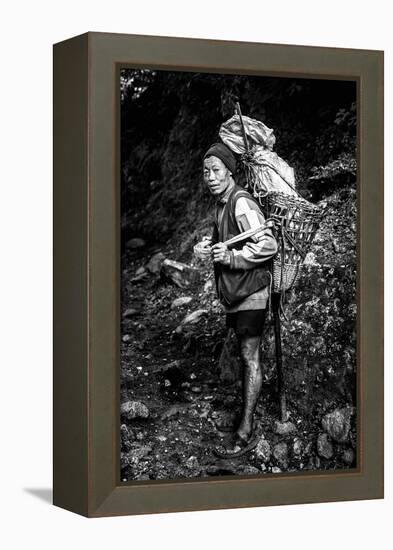 Black and white picture of a Sherpa carrying meat up to Everest Base Camp in Nepal-David Chang-Framed Premier Image Canvas