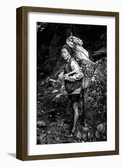 Black and white picture of a Sherpa carrying meat up to Everest Base Camp in Nepal-David Chang-Framed Photographic Print