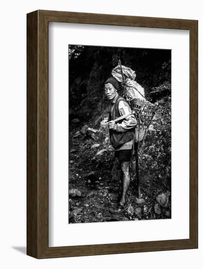 Black and white picture of a Sherpa carrying meat up to Everest Base Camp in Nepal-David Chang-Framed Photographic Print