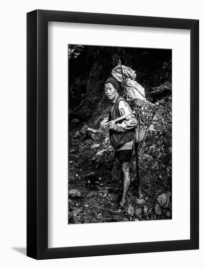 Black and white picture of a Sherpa carrying meat up to Everest Base Camp in Nepal-David Chang-Framed Photographic Print