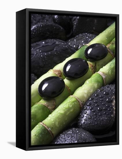 Black Stones on Bamboo-Uwe Merkel-Framed Premier Image Canvas