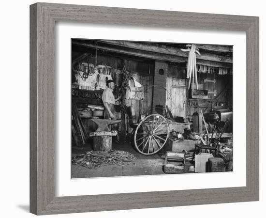 Blacksmith Working in His Shop-John Phillips-Framed Photographic Print