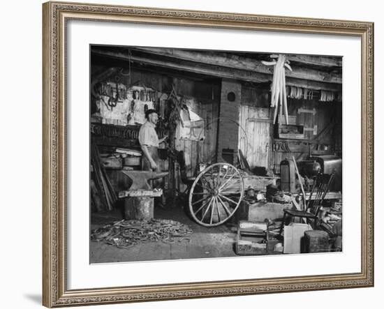 Blacksmith Working in His Shop-John Phillips-Framed Photographic Print