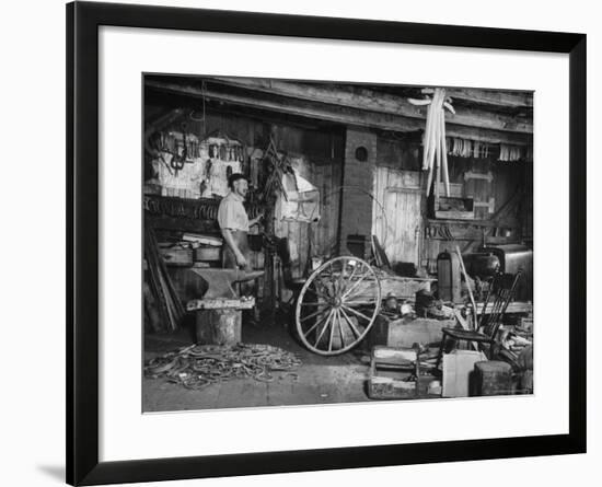 Blacksmith Working in His Shop-John Phillips-Framed Photographic Print