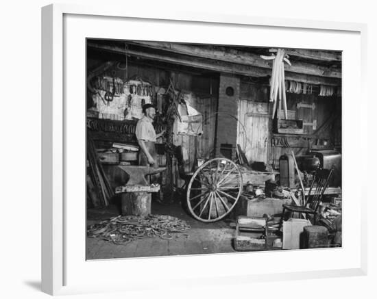 Blacksmith Working in His Shop-John Phillips-Framed Photographic Print