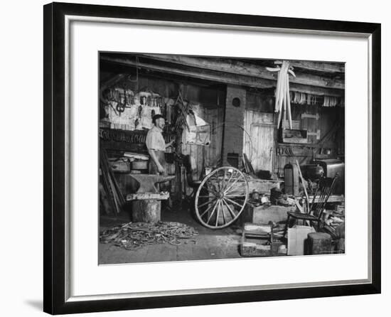 Blacksmith Working in His Shop-John Phillips-Framed Photographic Print