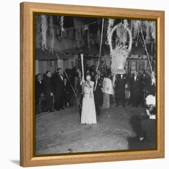 Blind Folded Woman Trying to Split Open the Pinata, During Traditional Pre-Christmas Celebration-Ed Clark-Framed Premier Image Canvas