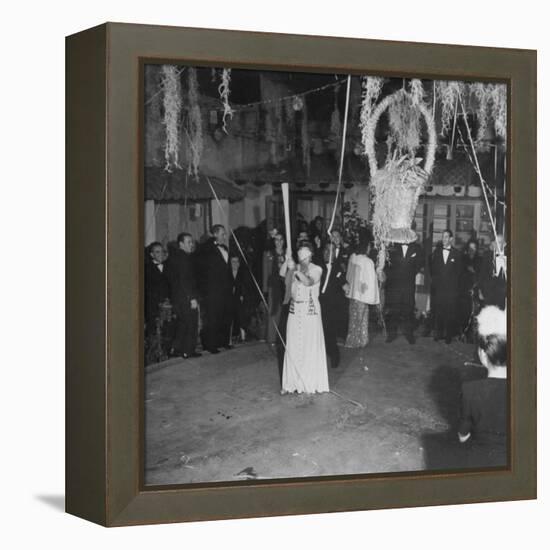 Blind Folded Woman Trying to Split Open the Pinata, During Traditional Pre-Christmas Celebration-Ed Clark-Framed Premier Image Canvas